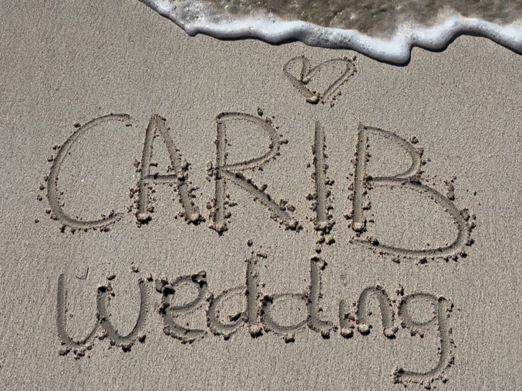 The name of our site written in the sand, on a Caribbean beach.