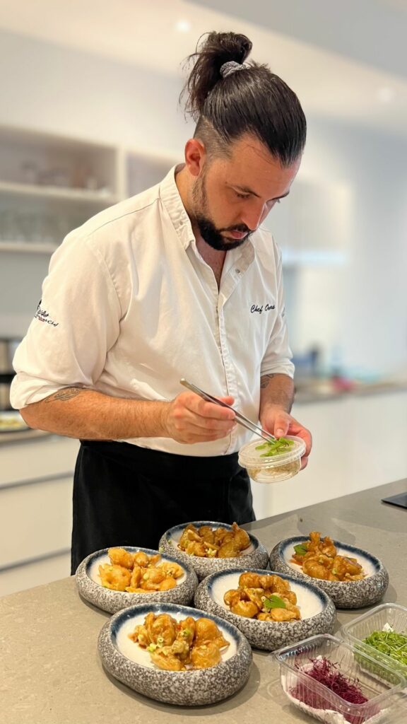 Chef plating gourmet dishes for a private dinner in a villa in Saint Martin