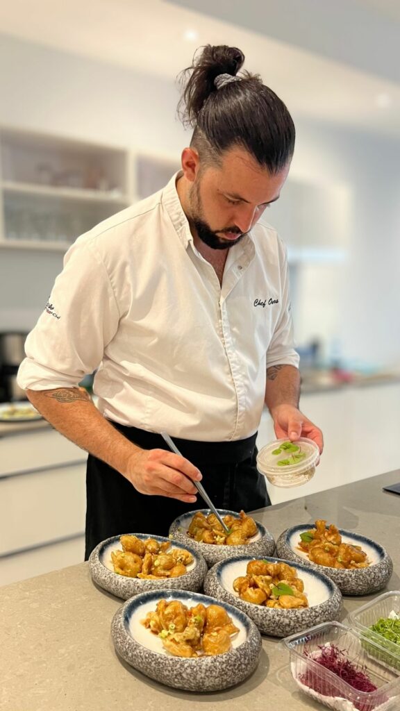 Chef from Ours Private Chef finishing dishes for a private villa dinner in Saint Martin